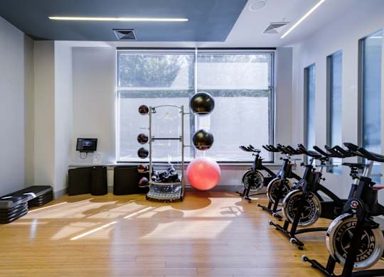 A gym with exercise bikes and a rowing machine.