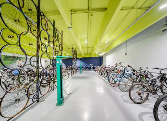 A bike shop with many bicycles hanging on the wall.