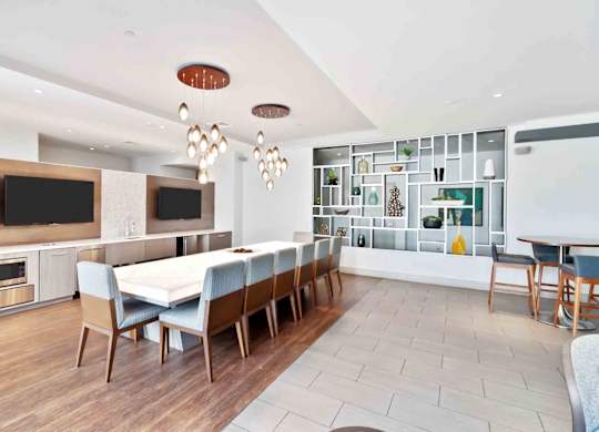 A modern dining room with a wooden table and chairs.