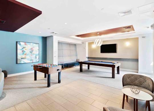 A room with a pool table and a couch.