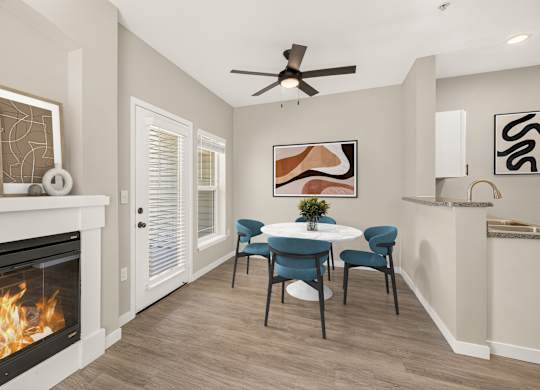 A modern living room with a fireplace and a dining table set up.
