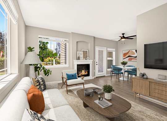 A living room with a fireplace, a couch, a chair, a coffee table, and a television.