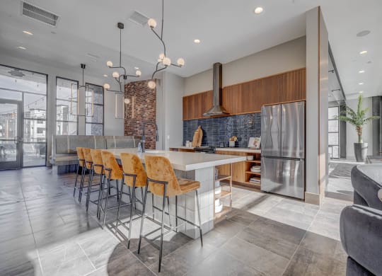 a kitchen with a large island and stainless steel appliances