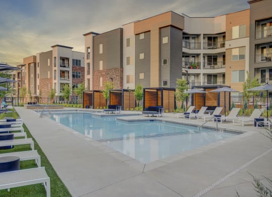 a swimming pool in front of an apartment building