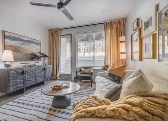 a living room with a couch and a ceiling fan
