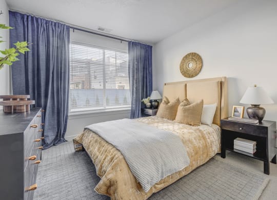 a bedroom with a large bed and a large window