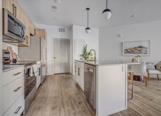 a kitchen with white cabinets and stainless steel appliances