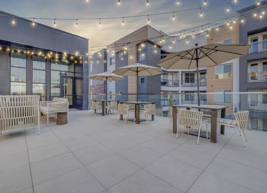 a patio with tables and chairs and umbrellas