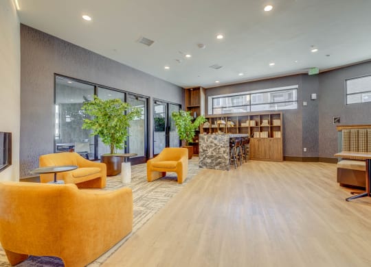 the lobby of a building with chairs and a table