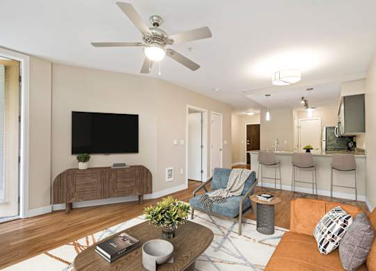 A living room with a television, a couch, a chair, and a coffee table.