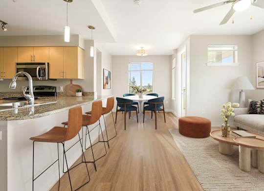 A modern kitchen with a dining area and a living room.