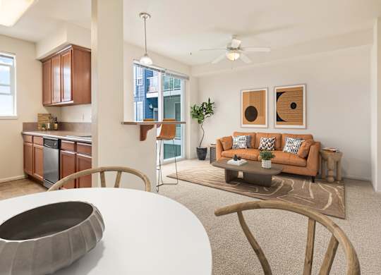 A modern living room with a white table and a brown couch.