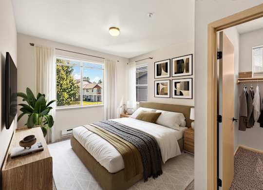 A bedroom with a large bed and a view of a house through the window.