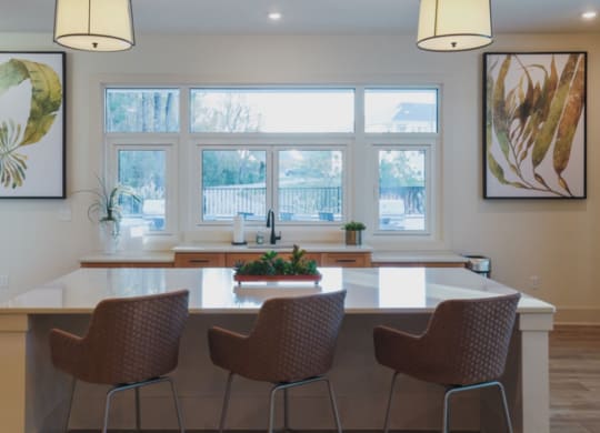 a kitchen with a large window and a table with four chairs