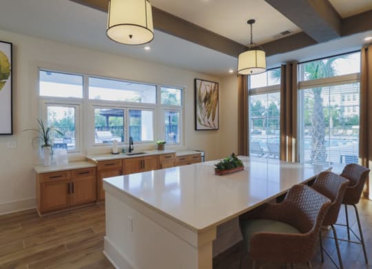 a kitchen with a large island and windows