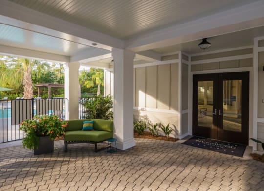 a front porch with a couch and a chair