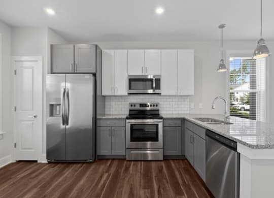 a kitchen with white cabinets and stainless steel appliances