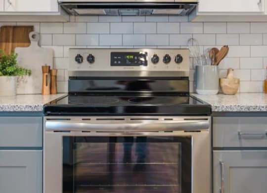 a stainless steel oven and microwave in a kitchen
