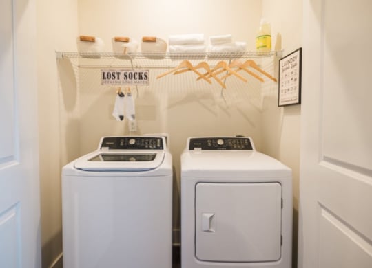 a white washer and dryer sit next to each other in a laundry room