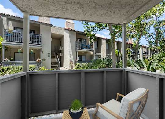 A patio with a chair and a potted plant.