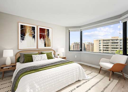 a bedroom with a large bed and a large window
