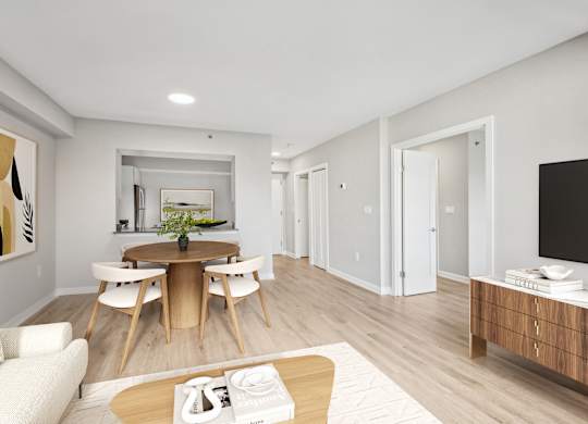 a living room and dining room with a table and chairs