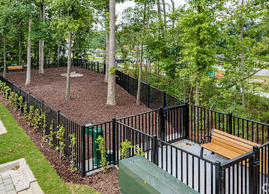 a park with benches and a fence
