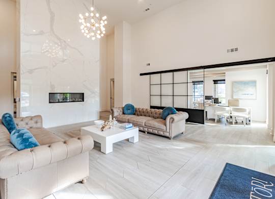 A modern living room with a large couch and a television.