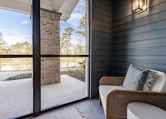 A patio with a couch and a pillow is shown.
