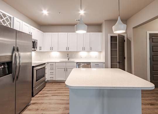 A modern kitchen with a large island in the center.