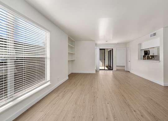 A room with wooden floors and white walls.