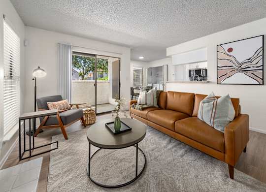 A living room with a brown couch and a coffee table.