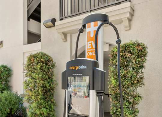 A ChargePoint electric vehicle charging station is installed on a sidewalk.