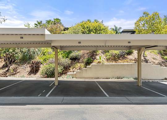 A row of parking spots with covered parking.