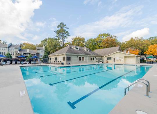 a large swimming pool with the building in the background