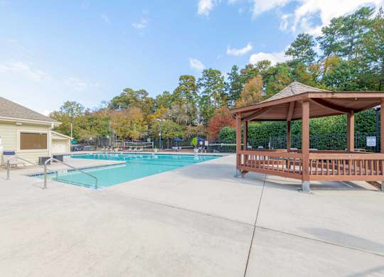 A pool with a gazebo next to it.