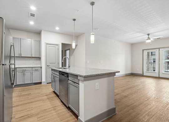 A modern kitchen with a refrigerator, cabinets, and a countertop.