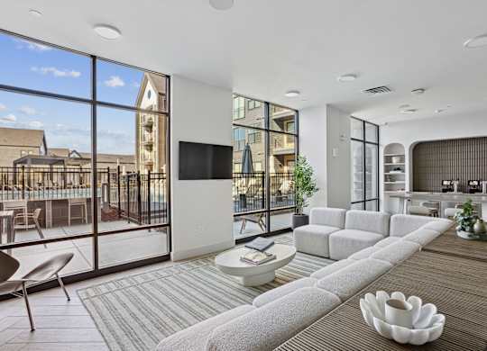 A modern living room with a large grey sofa and a flat screen TV.