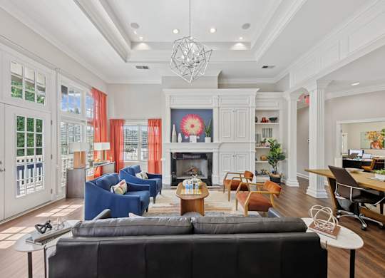A living room with a black couch and a fireplace.