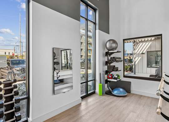 A modern room with a large mirror and a view of the outside.