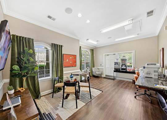 A living room with a television on the left and a dining area in the middle.