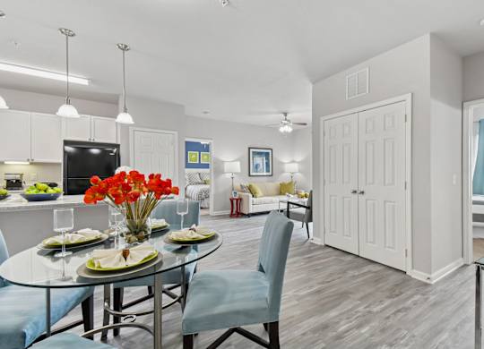 A dining room with a glass table and chairs.