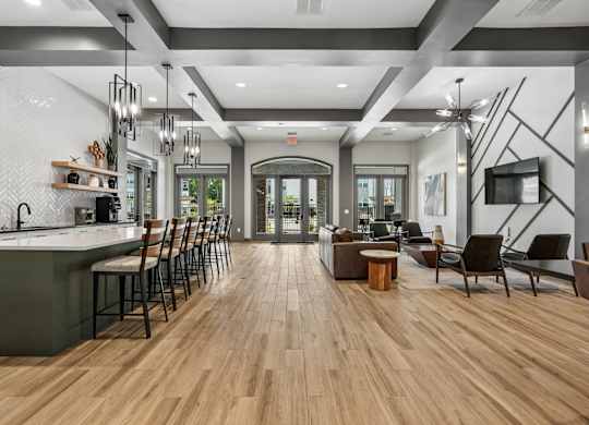 A modern kitchen with wooden floors and a long island.