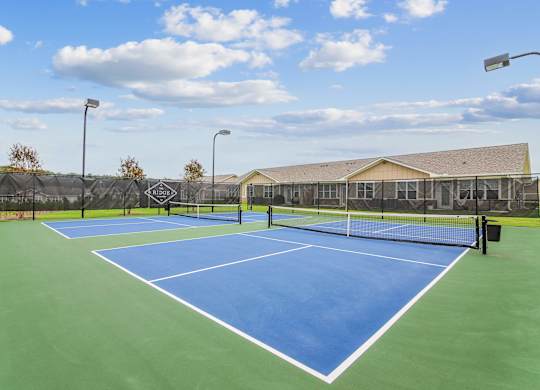 Tennis court with blue surface at The Ridge at Calhoun, Calhoun, GA