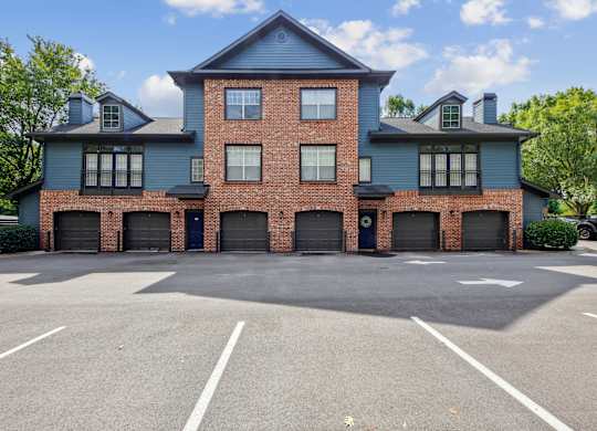 A large two-story building with a parking lot in front.