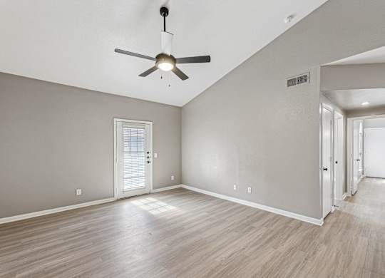 A room with a ceiling fan and wooden flooring at Clear Creek Meadows Apartments, Copperas Cove, Texas