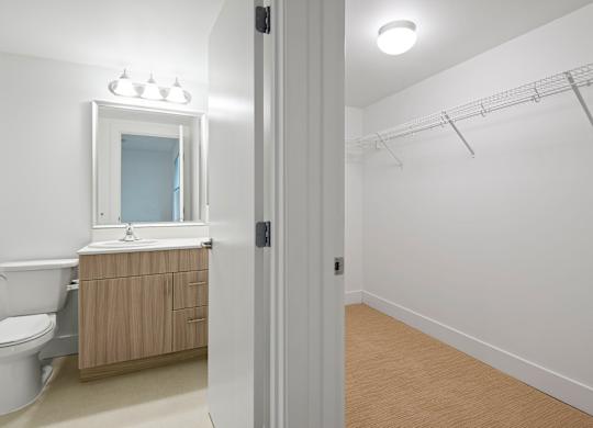 Bathroom with vanity and walk-in closet space at Six Oaks Apartments, Washington, 98011