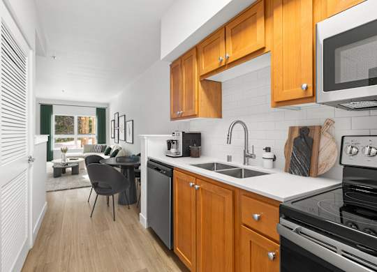 A kitchen with wooden cabinets and a black stove top oven.