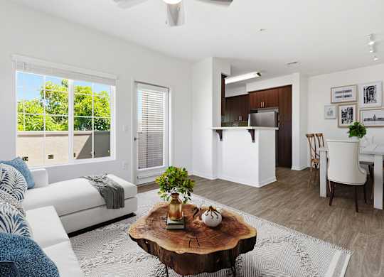 A living room with a white couch and a coffee table in the center.