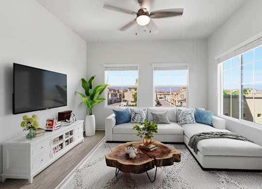 A living room with a white couch, a wooden coffee table, and a flat-screen TV mounted on the wall.